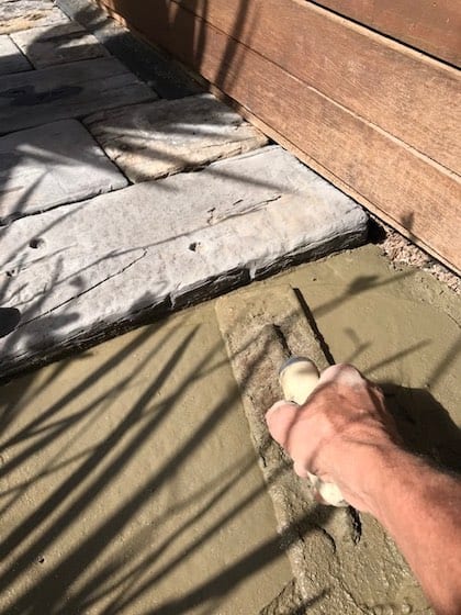 I'm using a concreter's trowel to level the concrete to a shiny surface.